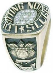 A gold ring with "Louisville Slugger" and "National" engraved on it, featuring a central cluster of small diamonds and an emblem with wings and "Opening" text.