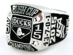 A silver championship ring with the text "Bush Cup Champions, Ducks, 43-7-0-1, 2015". The ring also features a duck logo and additional engravings.