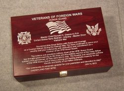 A wooden plaque from the Veterans of Foreign Wars, honoring Master Chief Donald C. Owens III for his service in the Navy and contributions to the VFW Honor Guard, with a dedication date of July 4, 2012.