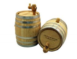 Two wooden barrels with metal bands and taps. One stands upright, the other is tilted. Engraved on the side is "Chelsea & George" with a date.