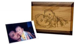 Photo of a man and a baby on the left, and a wooden plaque with an engraved version of the same image on the right.